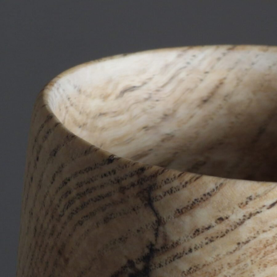 Close up of grain on spalted ash vessel